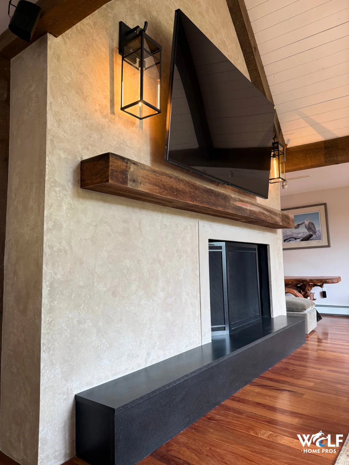 Custom fireplace wall with reclaimed wood mantel and mounted TV in Downingtown, PA