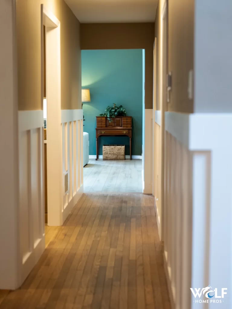 Hallway view from a Chester Springs, PA first-floor remodel with new hardwood flooring and updated trim by Wolf Home Pros.