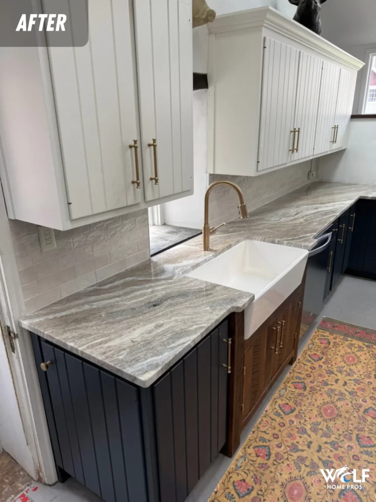 After view of the Downingtown kitchen refresh featured by Wolf Home Pros, showing the finished sink area, light counters, and tile backsplash.