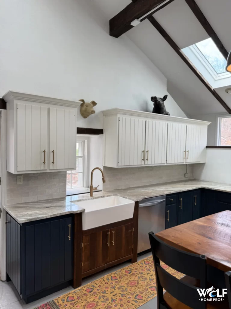 Finished Downingtown kitchen showing the farmhouse sink, counters, tile backsplash, and existing dark lower cabinets