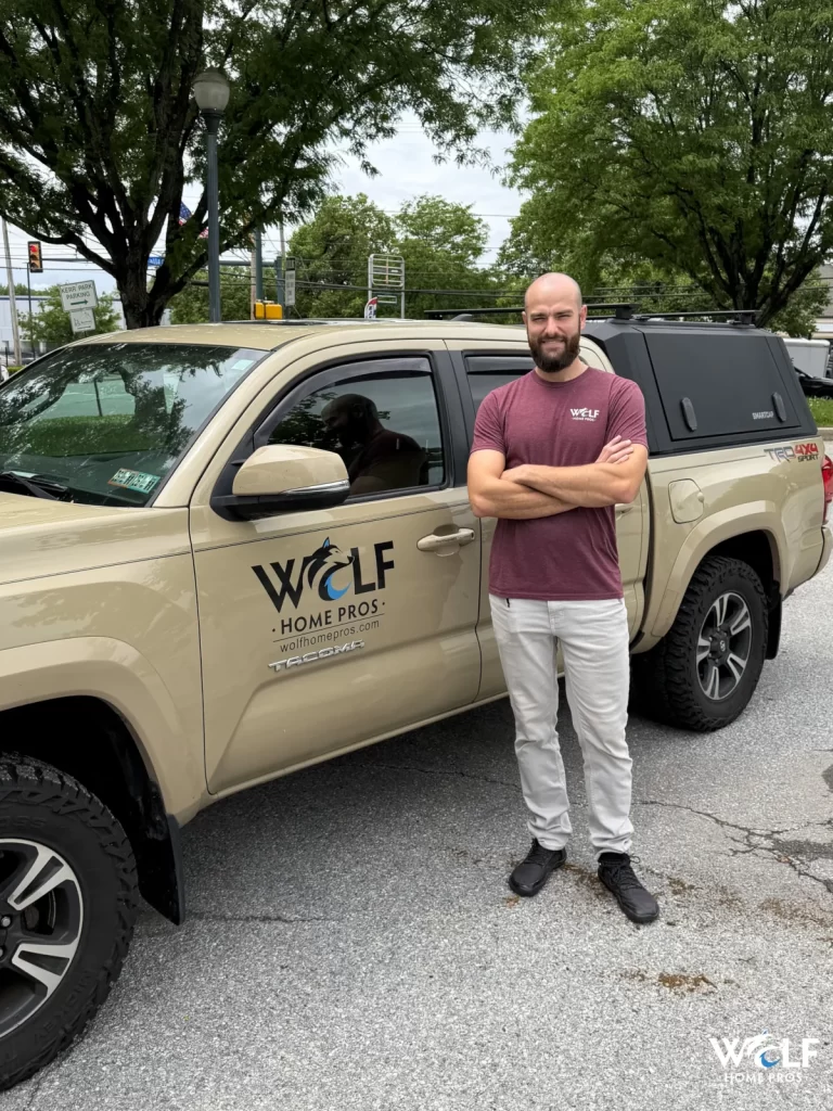 James Wolf standing beside a Wolf Home Pros work truck.