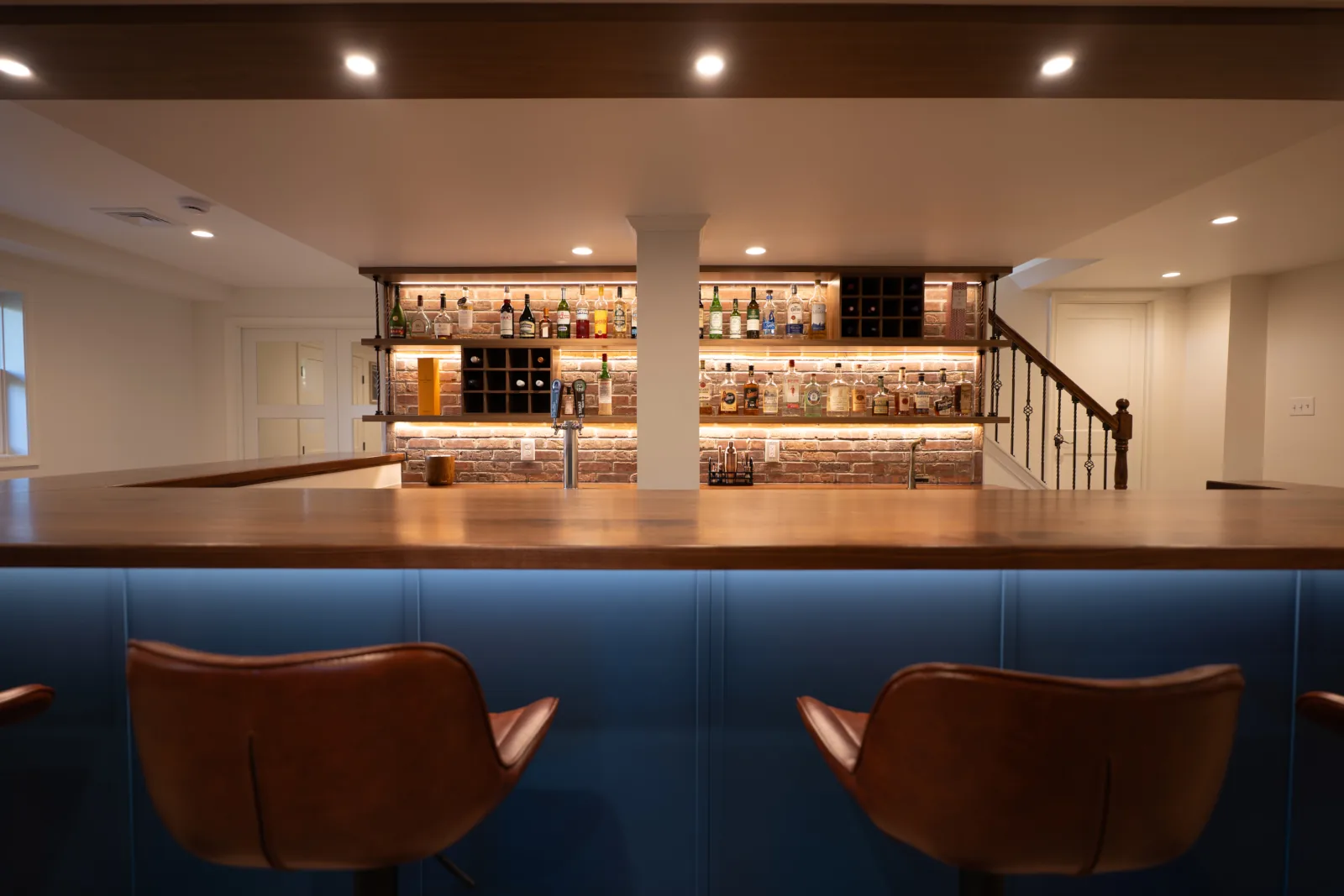 Custom wet bar in a finished basement remodel in West Chester, PA by Wolf Home Pros