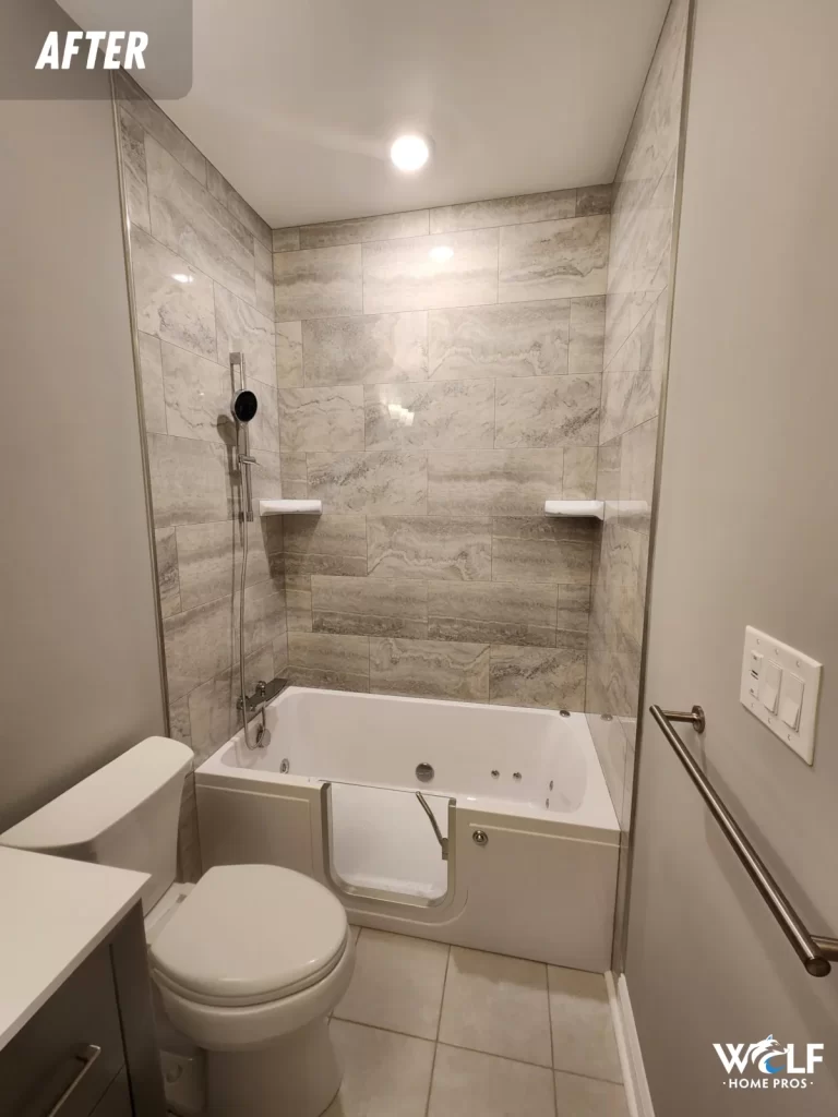 Completed West Chester, PA bathroom remodel with an updated tub, tiled surround, handheld shower fixture and new finishes.