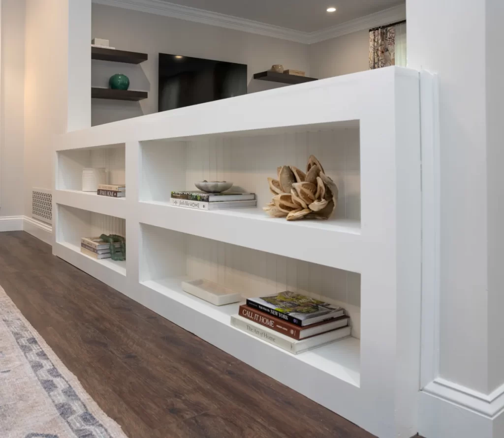 Custom built-in shelving and floating wall shelves in a remodeled Coatesville, PA living room