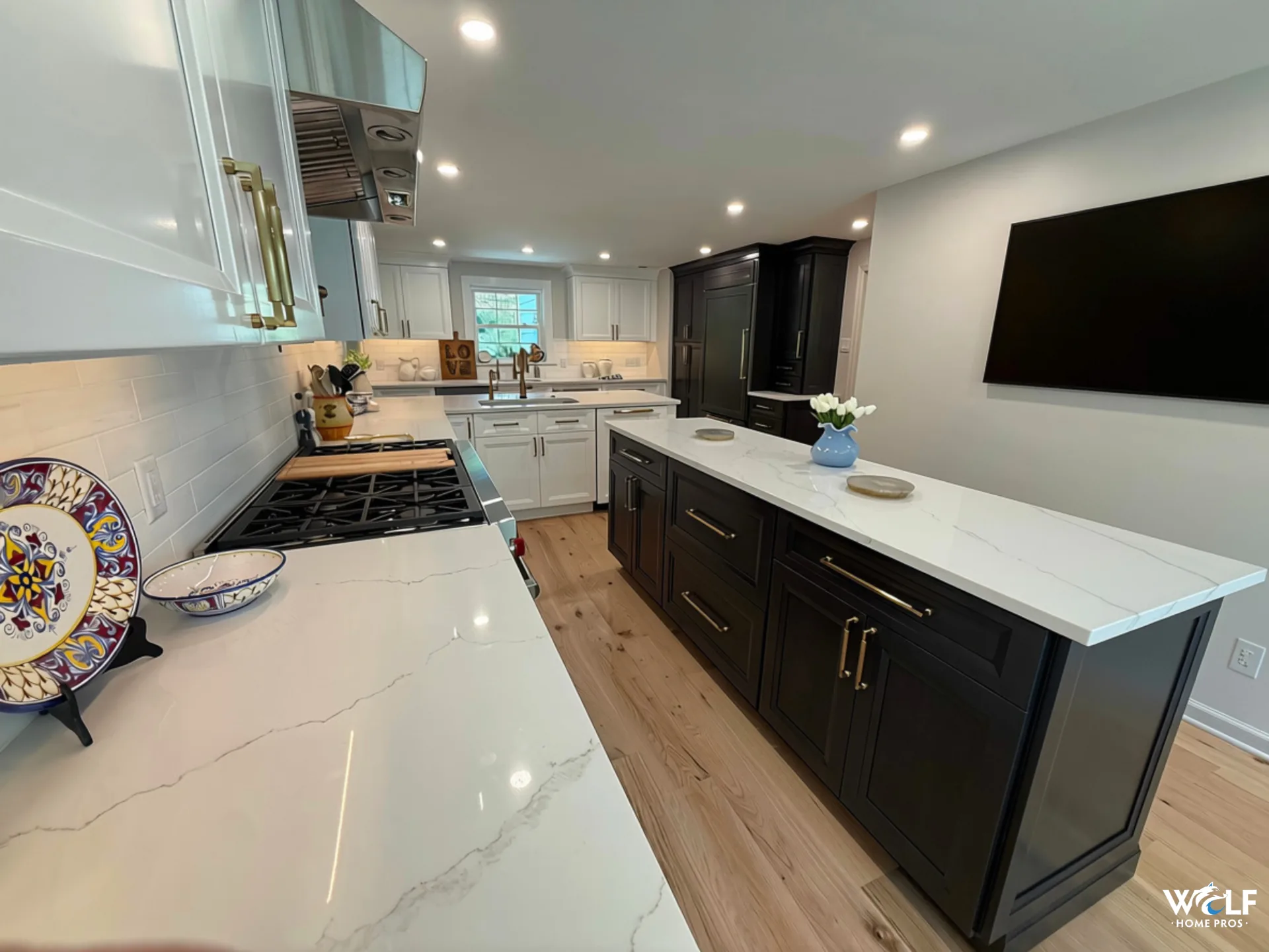 Finished Gladwyne, PA kitchen remodel by Wolf Home Pros with custom cabinetry, built-ins, kitchen island and coordinated finish carpentry.