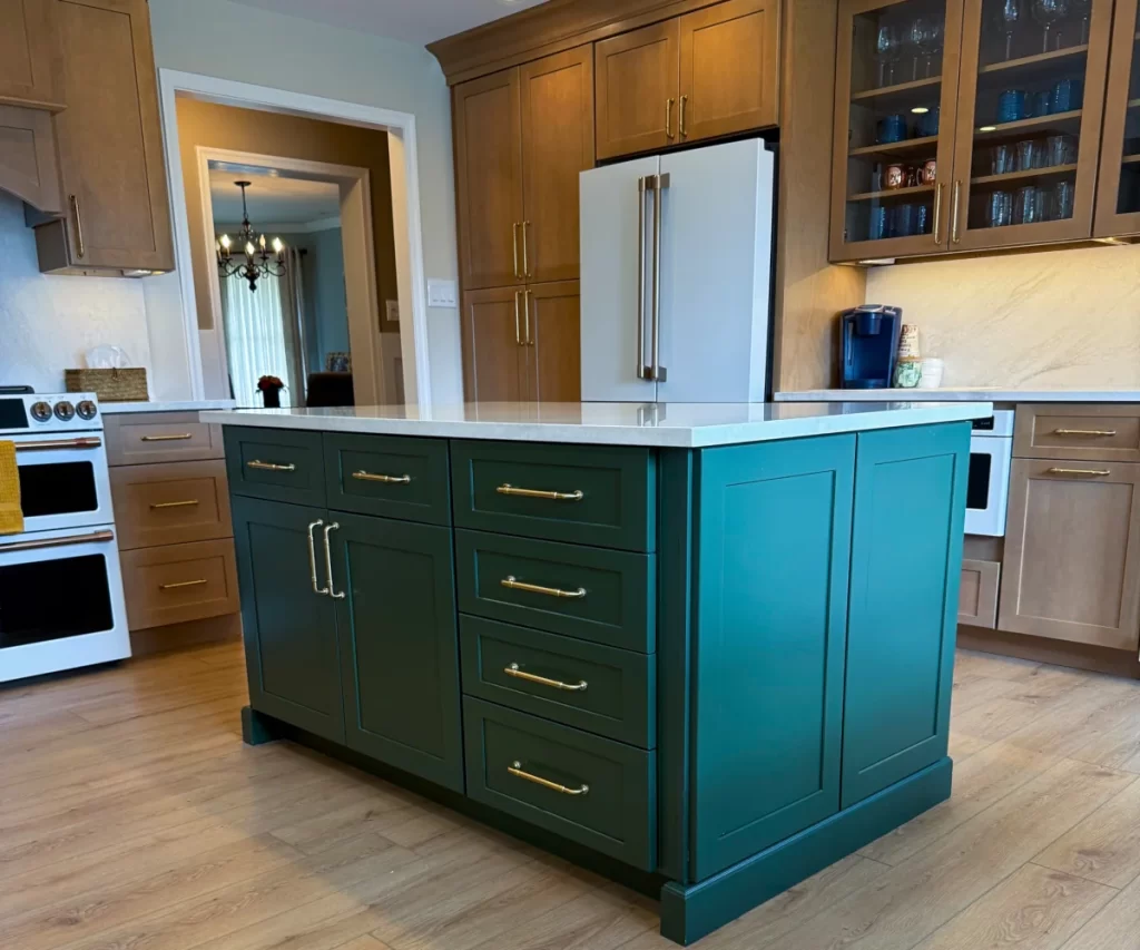 Custom kitchen island with built-in storage, green cabinetry and surrounding custom cabinets in Chester Springs, PA.