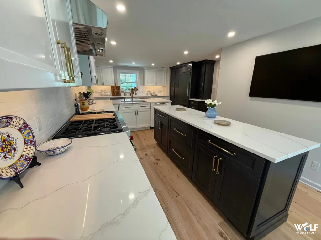 Finished kitchen remodel in Gladwyne, PA by Wolf Home Pros featuring custom island cabinetry, kitchen cabinets, built-ins, and new flooring.