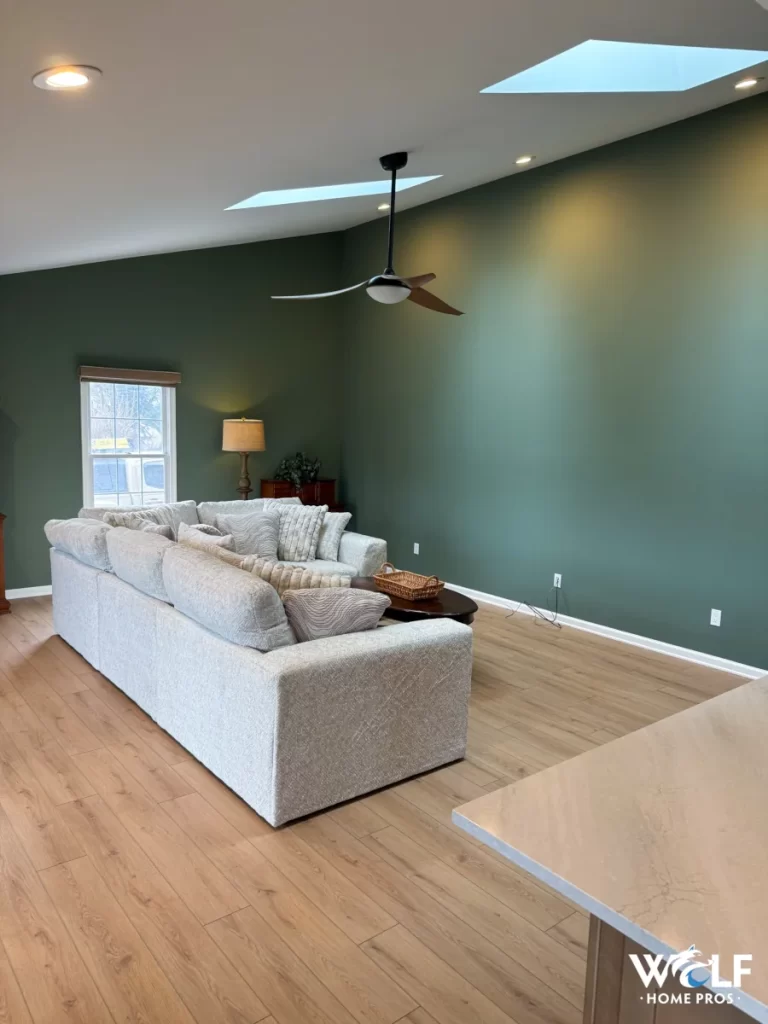 Living room from a Chester Springs, PA first-floor remodel with new hardwood flooring, ceiling fan, and updated lighting by Wolf Home Pros.