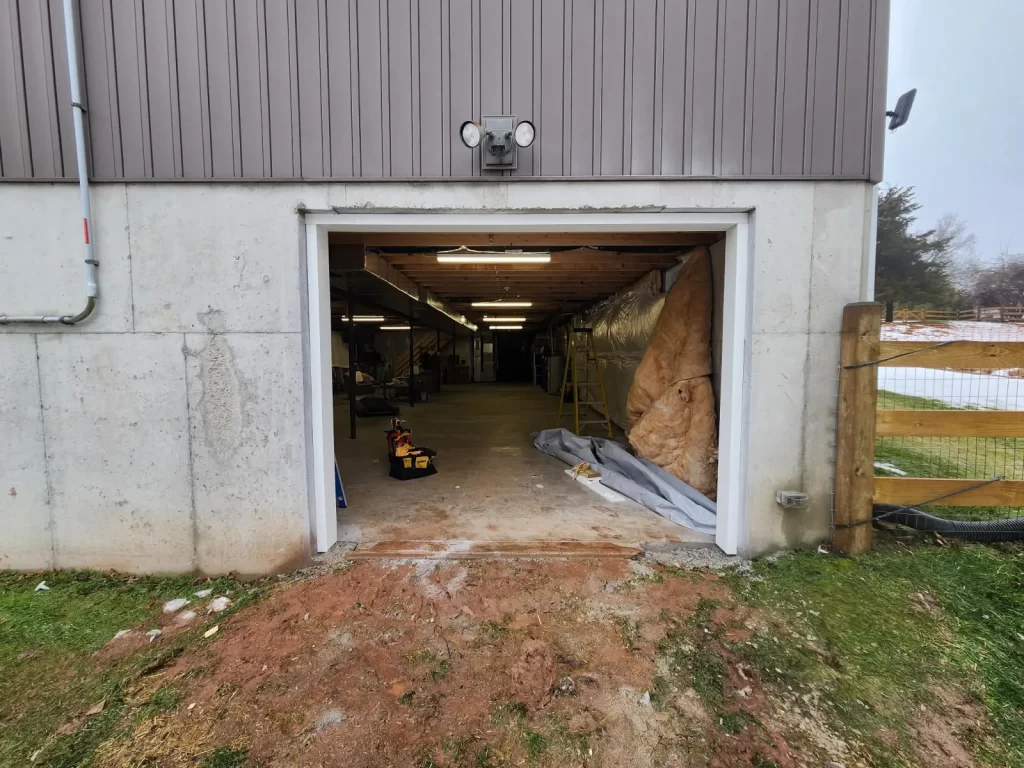 Basement garage door opening in Phoenixville, PA after concrete and foundation cutting for a new garage door installation by Wolf Home Pros.