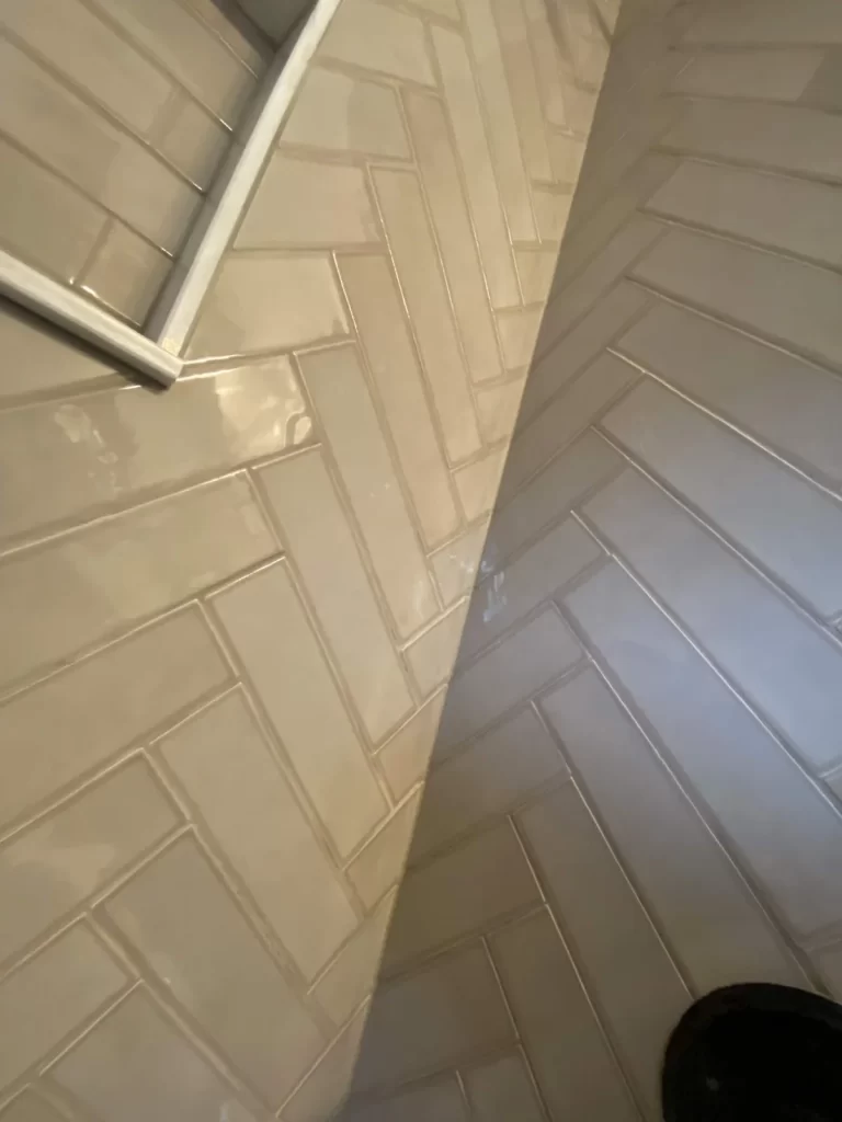 Close-up of bathroom tile work in Phoenixville, PA showing carefully aligned tile joints around a corner by Wolf Home Pros.
