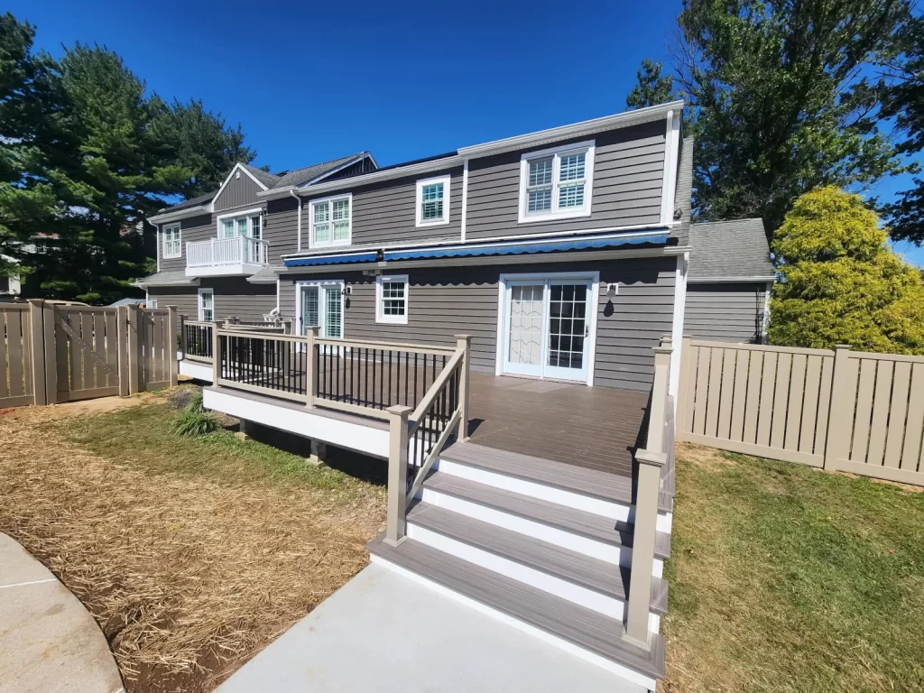 Finished deck build in Phoenixville, PA with new stairs, railings, and backyard access by Wolf Home Pros.