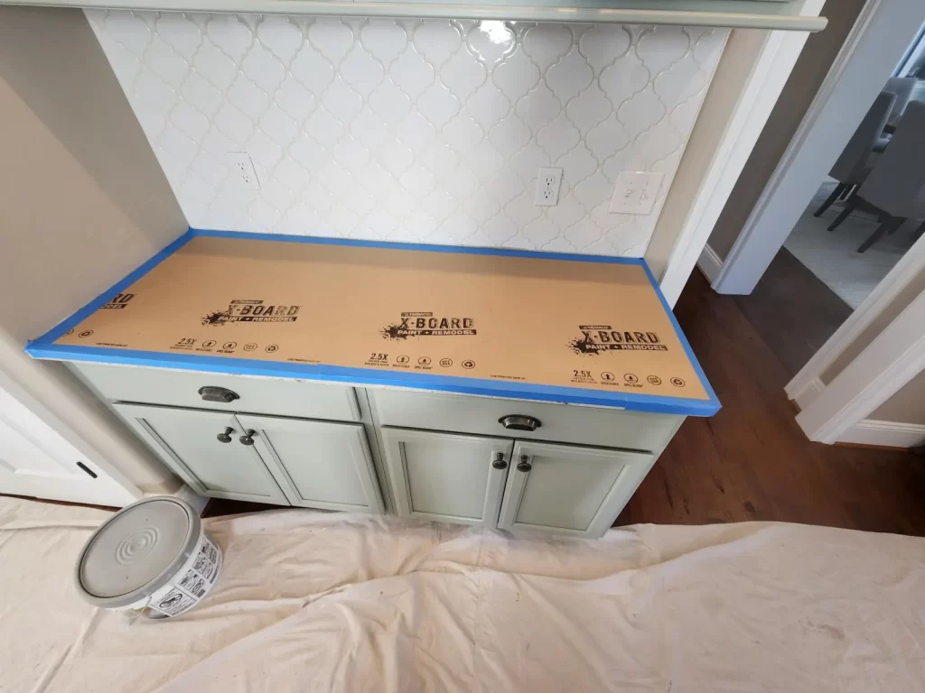 Protected countertop and cabinetry during a West Chester, PA kitchen backsplash project.